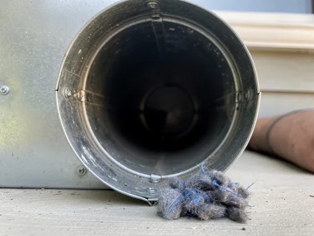 Laguna Woods Dryer Vent Cleaning technician using specialized equipment to clear severe dryer vent blockage in Laguna Woods